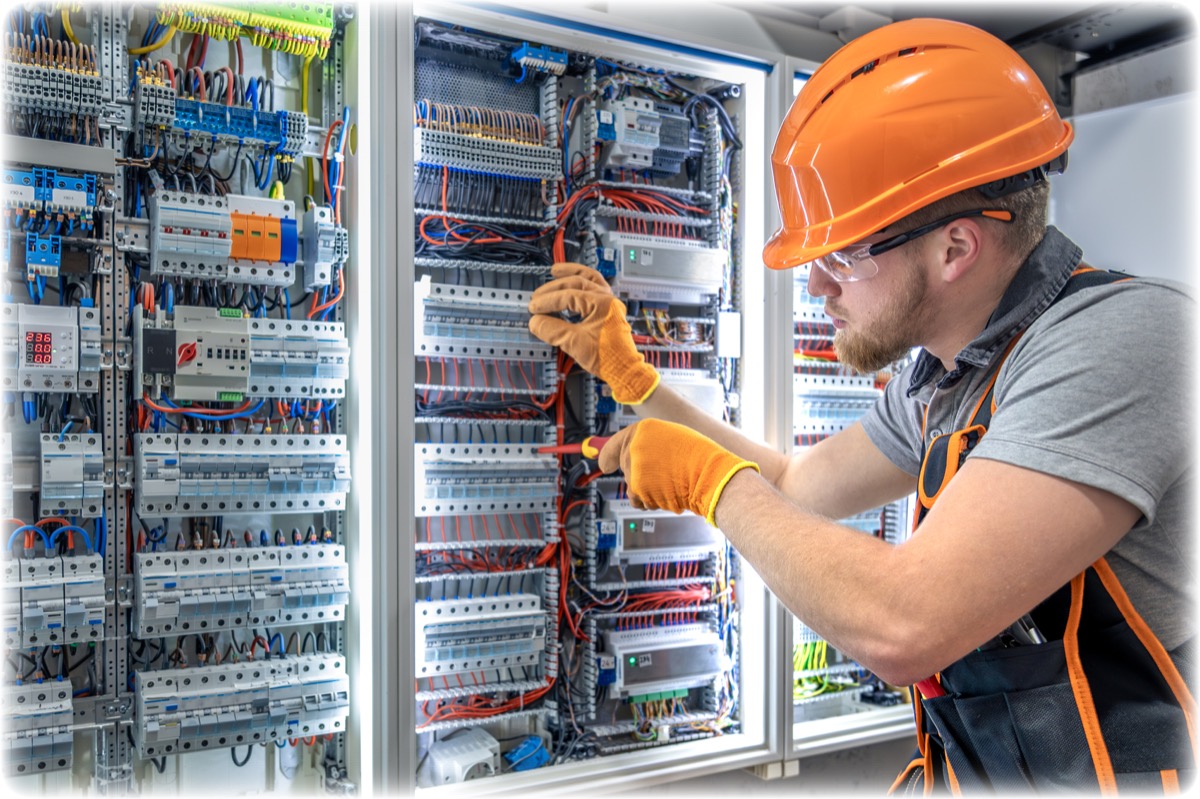Electrician inspecting a residential breaker panel